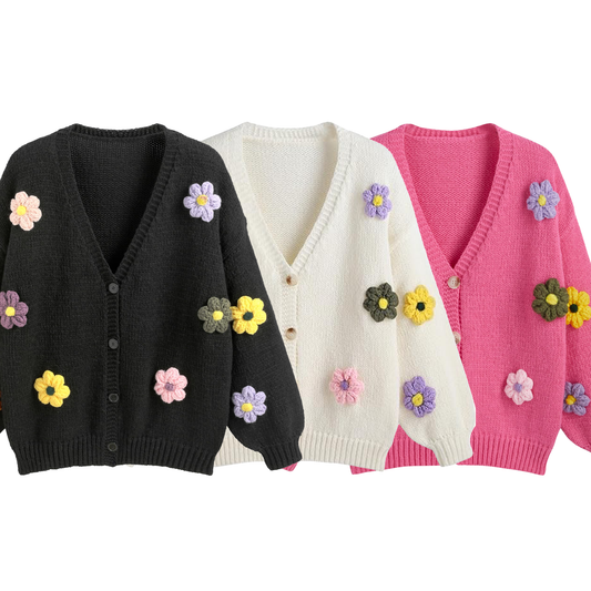 Three cardigans in black, white, and pink with floral embellishments on a white background.