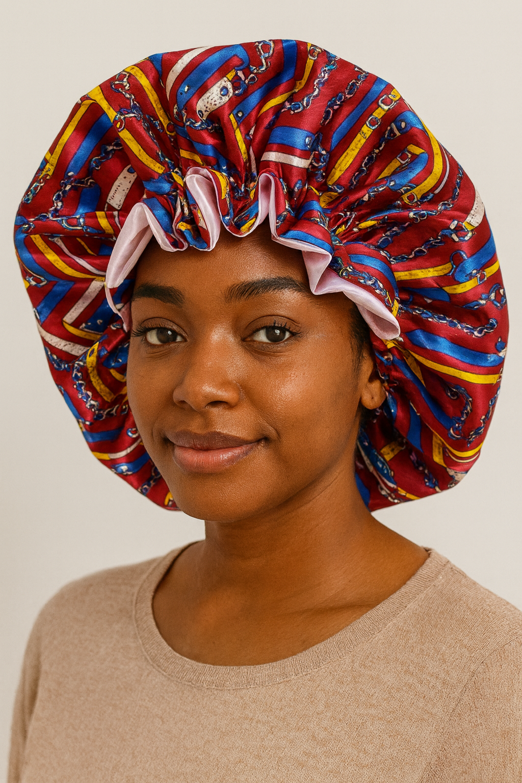 Woman wearing a colorful patterned bonnet against a plain background