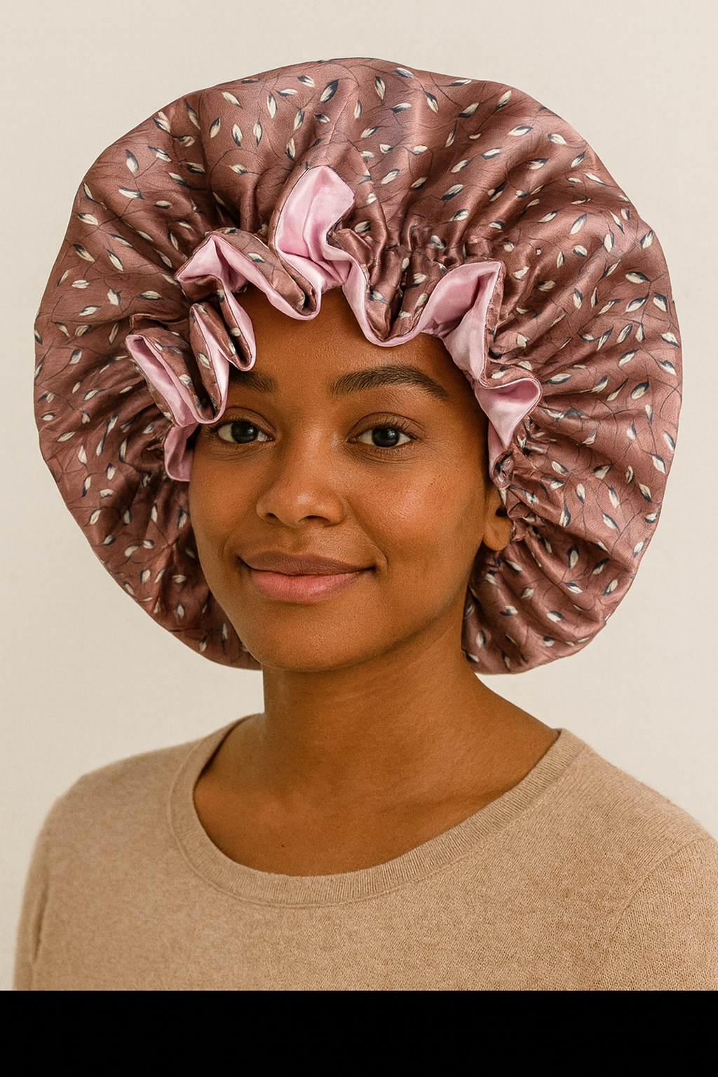 Woman wearing a patterned satin bonnet on a beige background