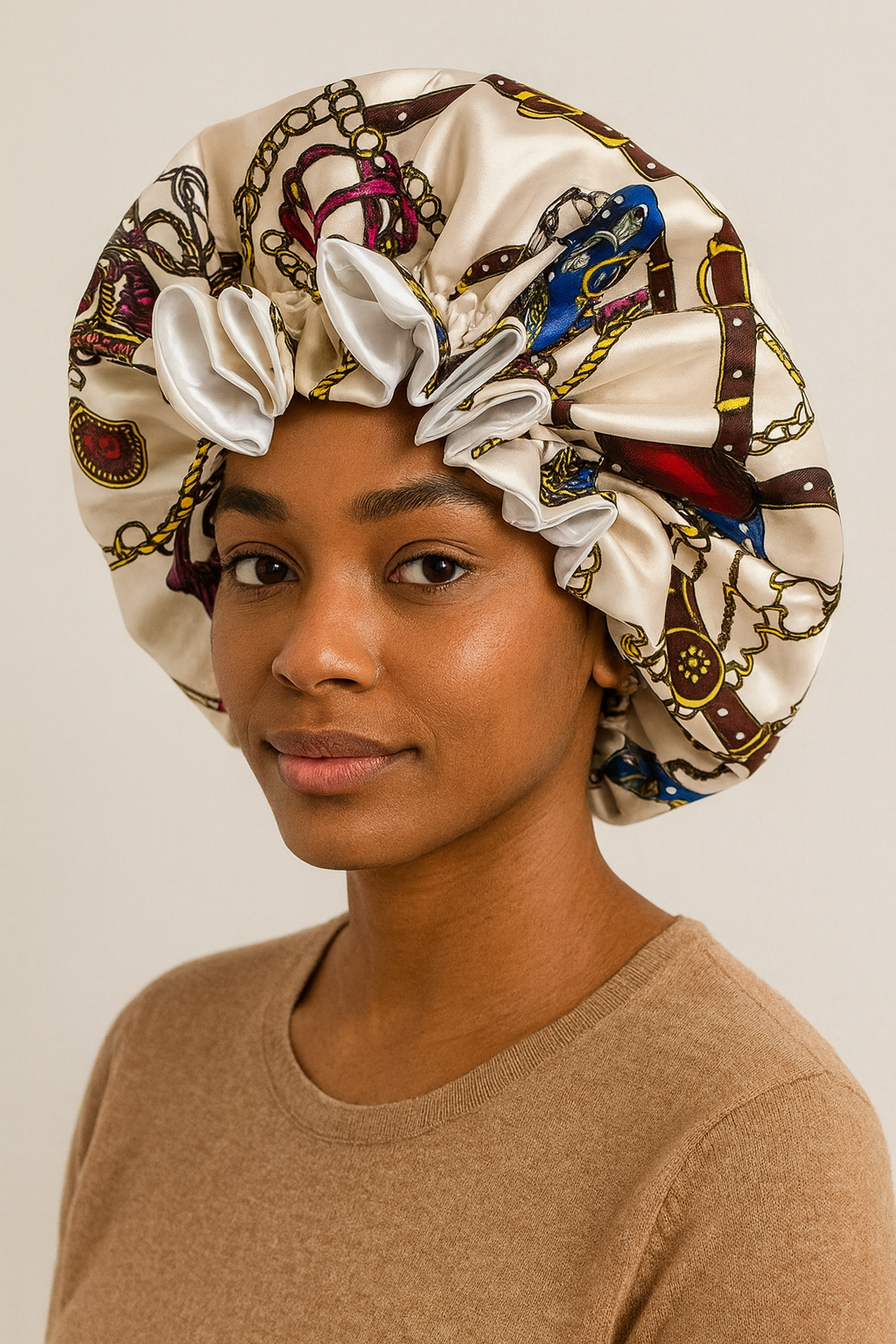 Woman wearing a decorative satin bonnet against a plain background