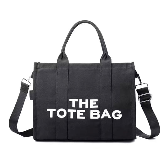 Black tote bag with 'THE TOTE BAG' text on a white background