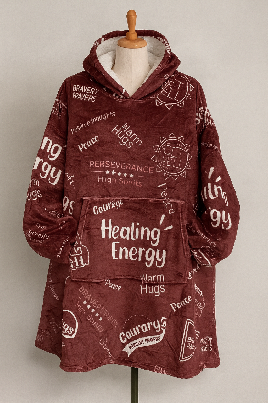 Maroon hoodie with text design on a mannequin against a plain background