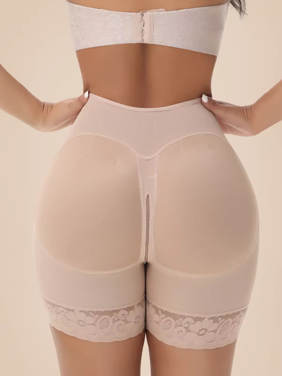 Beige shapewear with lace trim on a beige background