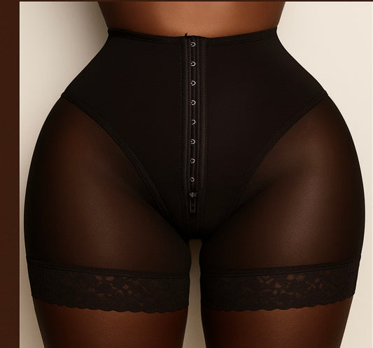 Black shapewear with lace details on a neutral background